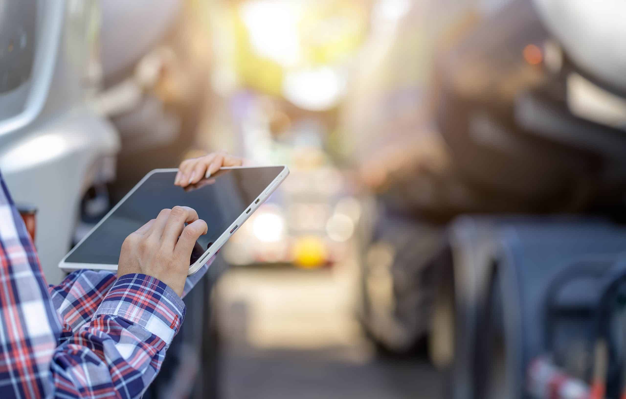 Maintenance technician using tablet to perform paperless truck maintenance